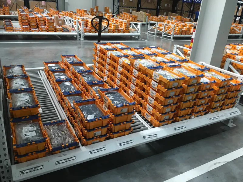 Carton flow rack. Carton flow with product box on rollers.