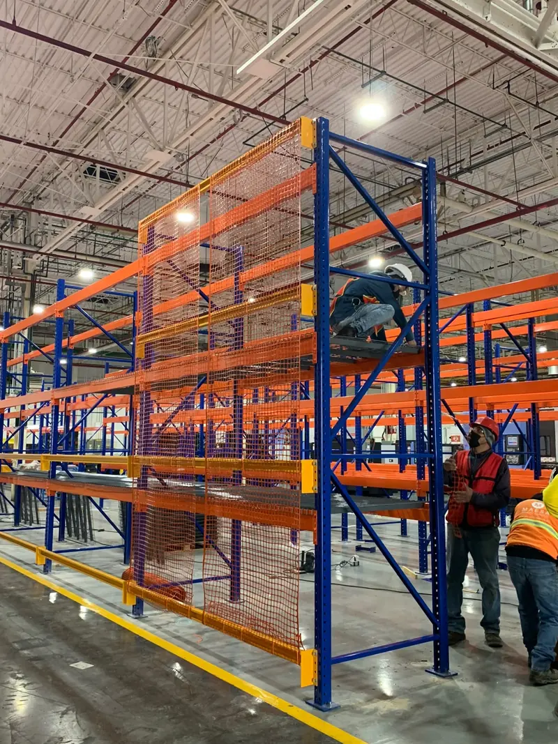 Installation. Safety mesh being mounted on a rack.