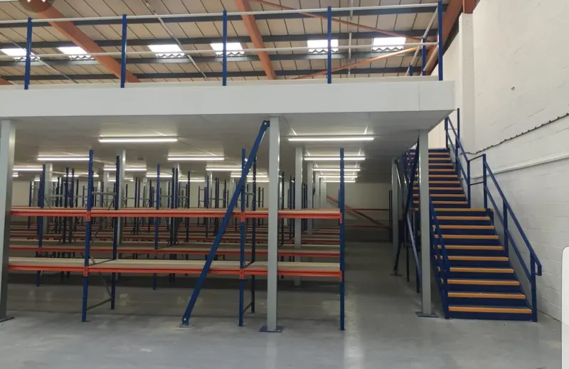 Industrial mezzanine. Mezzanine with stairs and rack below the level.