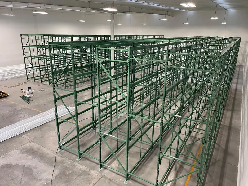 Selective pallet rack. Selective rack structure in green finish during assembly.